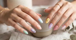Close-up of stylish manicured hands featuring micro nail art with pastel colors, glossy and matte polish combination, elegant fashion styling, soft lighting with modern aesthetic.